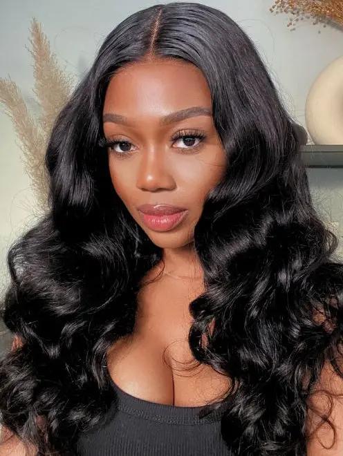 A woman with long, glossy, natural black body wave wavy human hair wig on WigOutlets