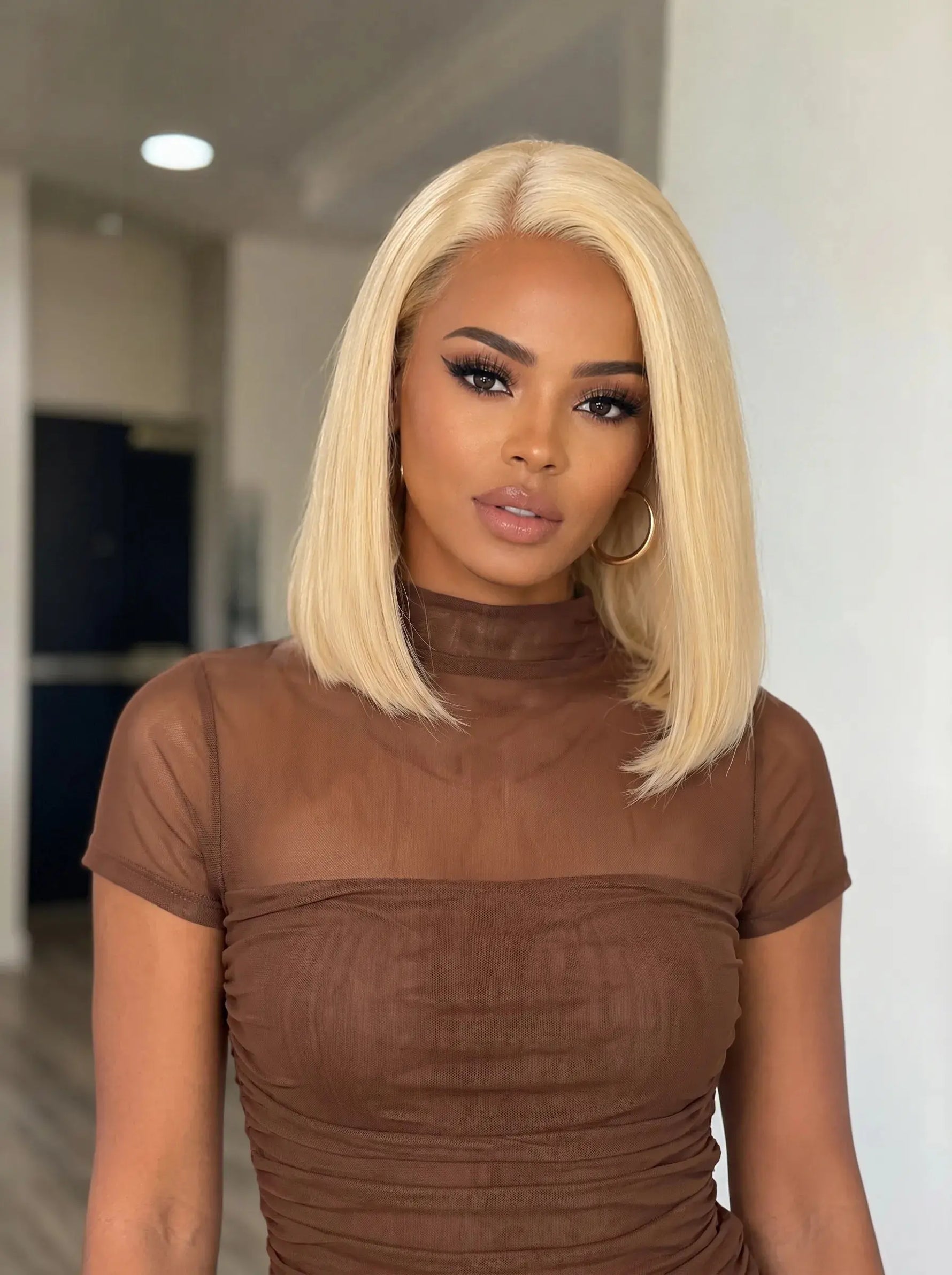 Glueless 613 Blonde Bob Wig with Pre-Plucked 4x4 HD Lace on model.