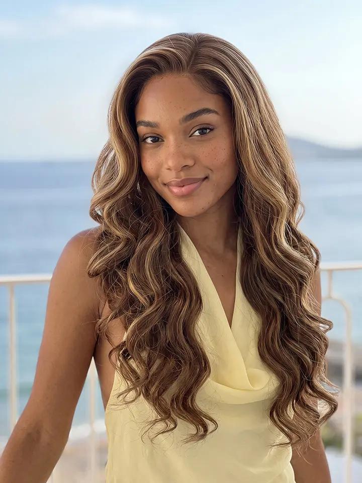 A woman with long body wave highlighted brown human hair wig from WigOutlets